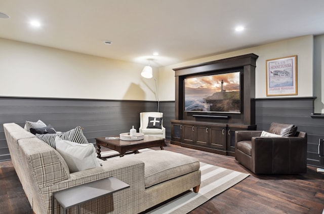 home theater room with dark wood-type flooring, recessed lighting, and a wainscoted wall