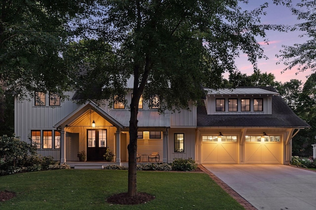 view of front of property with a lawn and a garage