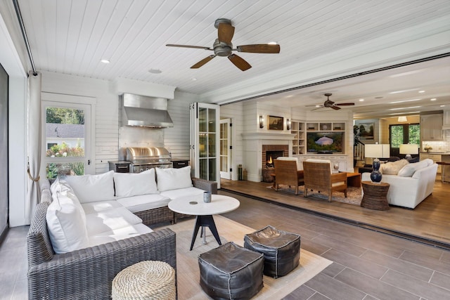 living room with ceiling fan, wood ceiling, and hardwood / wood-style floors