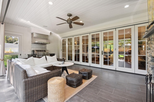 sunroom / solarium featuring wood ceiling and ceiling fan