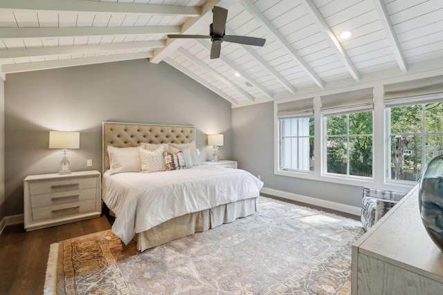 bedroom with lofted ceiling with beams, wood finished floors, baseboards, and ceiling fan