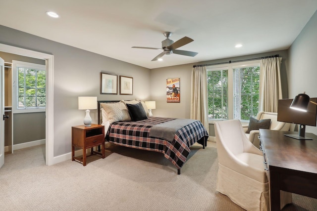 bedroom with ceiling fan and light carpet