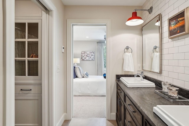 bathroom featuring vanity, tasteful backsplash, and tile patterned floors