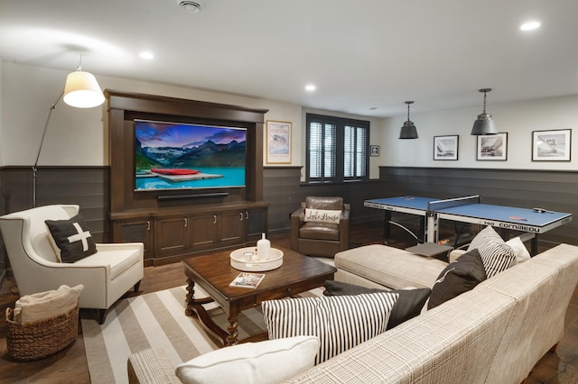 home theater room with wood walls and hardwood / wood-style flooring