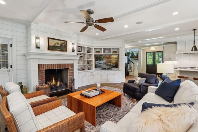 20545 Linwood Rd, Deephaven, MN 55331 - living room featuring crown molding, a ceiling fan, recessed lighting, a fireplace, and wood finished floors