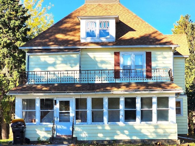 back of house featuring a balcony