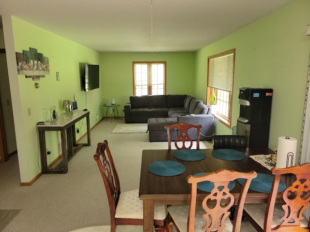 dining area featuring light colored carpet