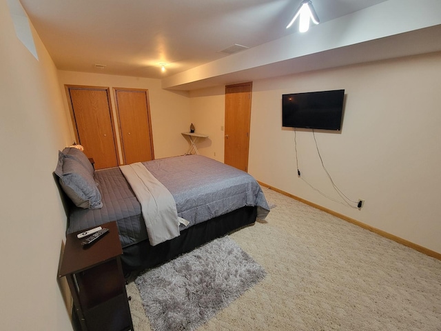 bedroom with carpet flooring, visible vents, and baseboards