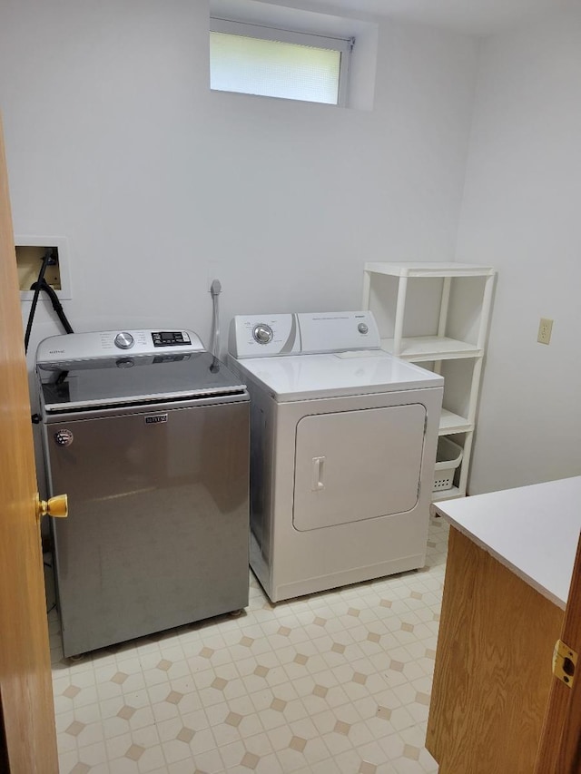 laundry room featuring laundry area, light floors, and washer and clothes dryer