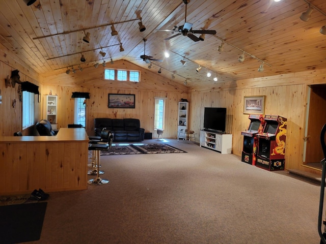 living room with wooden walls, carpet, lofted ceiling, rail lighting, and wood ceiling