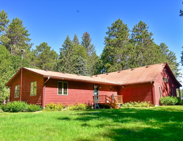 rear view of house featuring a yard