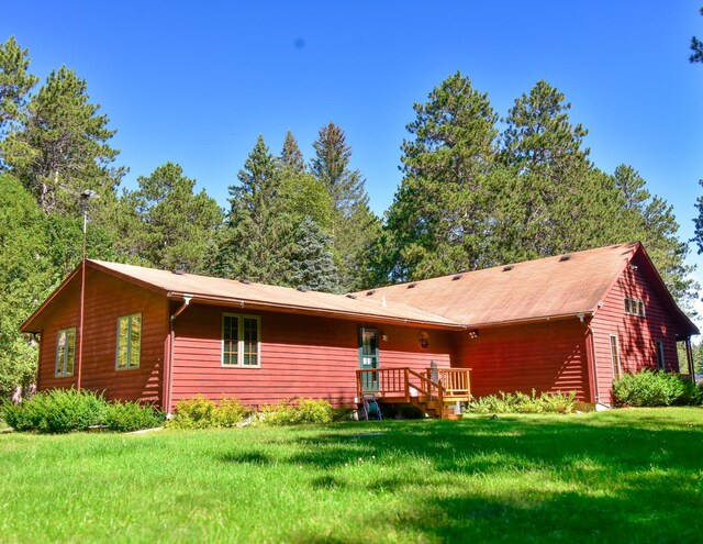 26451 US-71, Arago Twp, MN 56470 - rear view of property featuring a lawn and a wooden deck