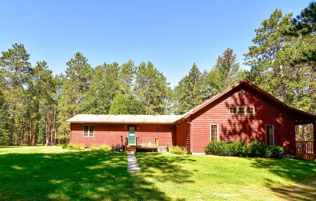 rear view of property with a lawn