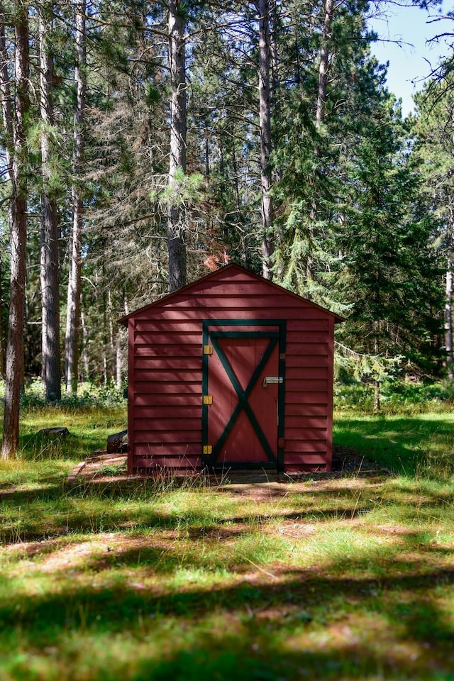 view of shed featuring a forest view