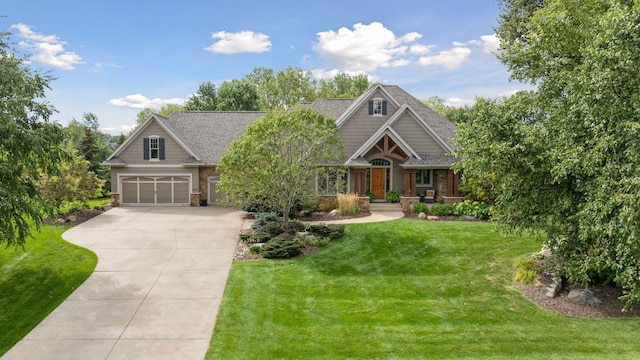 craftsman house with a garage and a front lawn