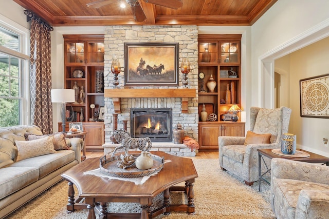 interior space featuring a healthy amount of sunlight, a stone fireplace, and wood ceiling