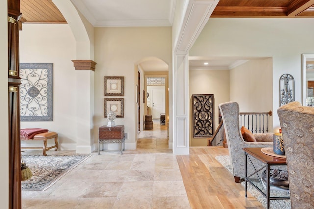 entrance foyer with ornate columns, ornamental molding, and wooden ceiling