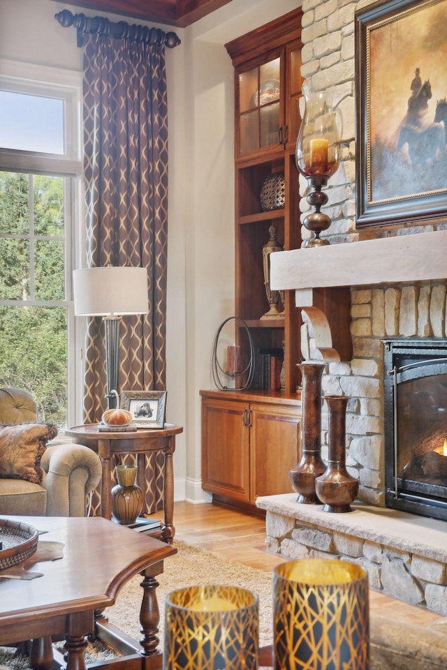 living room with light wood-type flooring and a fireplace