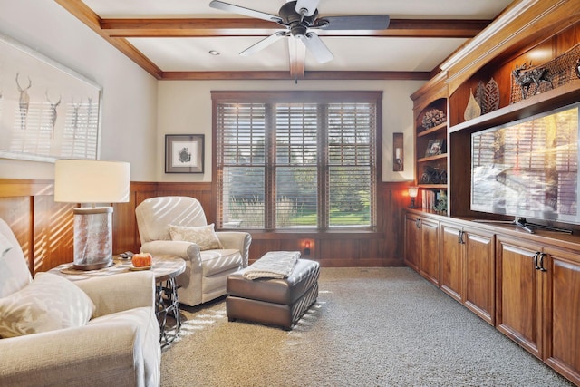 sitting room featuring beamed ceiling, coffered ceiling, light carpet, ceiling fan, and wood walls