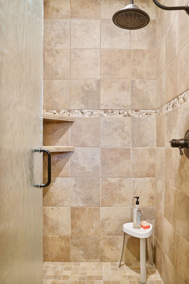 bathroom with a tile shower