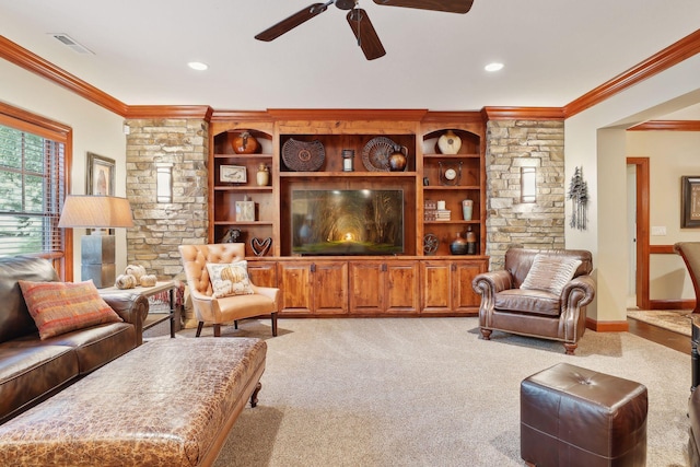 carpeted living room with ceiling fan and crown molding