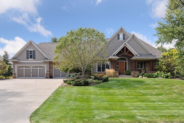 craftsman house featuring a garage and a front yard