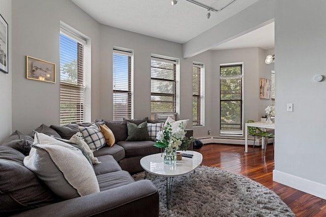 living room featuring a textured ceiling, a baseboard radiator, and dark hardwood / wood-style floors