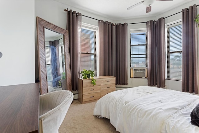 carpeted bedroom featuring cooling unit, multiple windows, ceiling fan, and a baseboard radiator