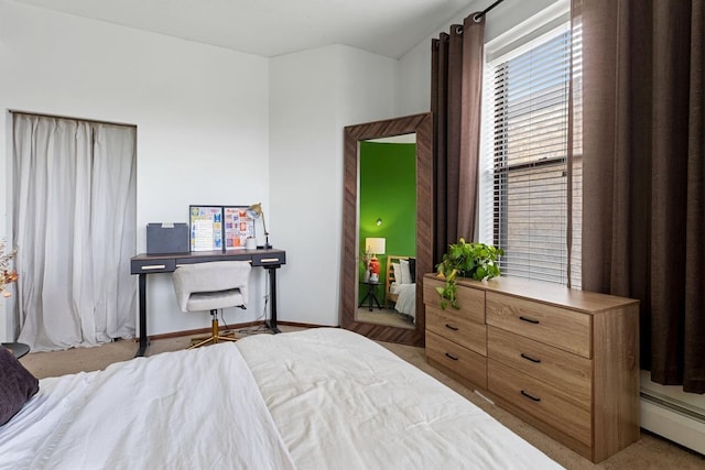 carpeted bedroom with baseboard heating