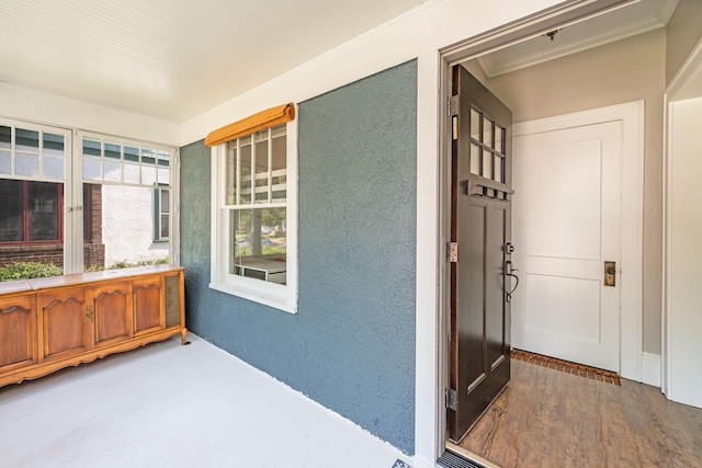 doorway to property featuring a porch