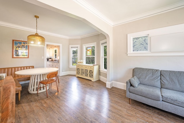 dining area featuring crown molding and wood-type flooring