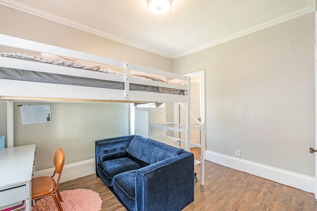 bedroom featuring hardwood / wood-style flooring and ornamental molding