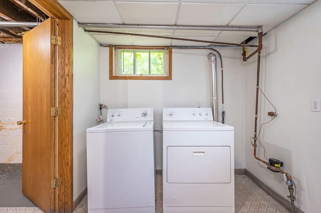 clothes washing area with washing machine and clothes dryer