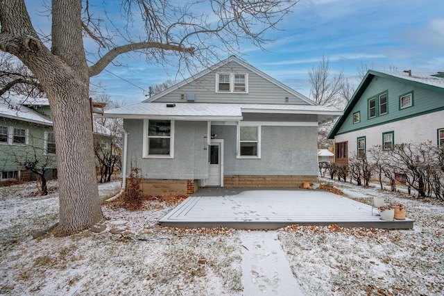 bungalow-style home featuring a wooden deck