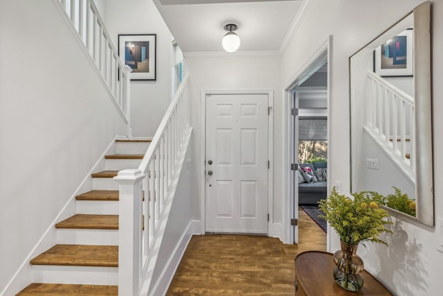 foyer entrance featuring ornamental molding and dark wood-type flooring