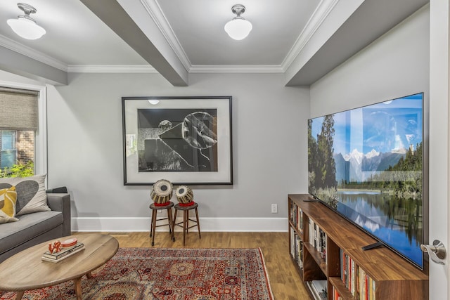 living area with dark hardwood / wood-style floors and ornamental molding