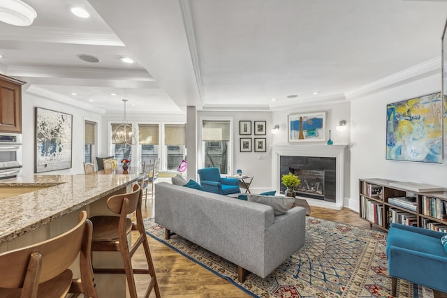 living room featuring a tray ceiling, dark hardwood / wood-style floors, and ornamental molding