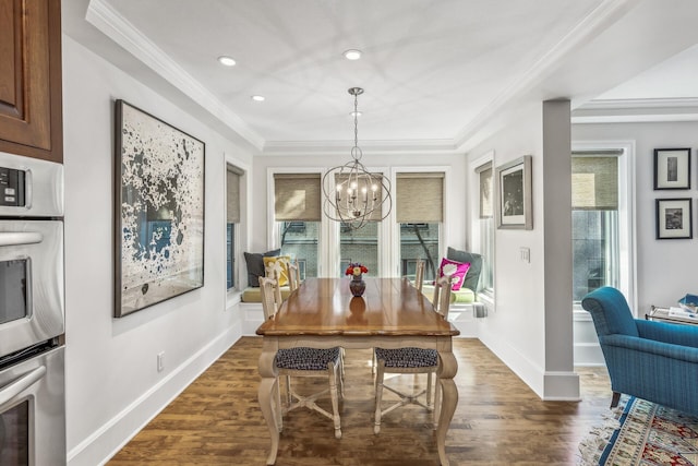 dining area featuring dark hardwood / wood-style floors, a chandelier, and crown molding