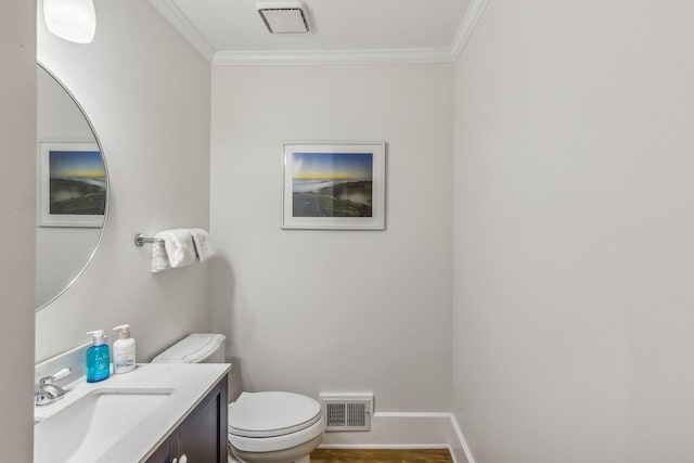 bathroom featuring ornamental molding, vanity, and toilet