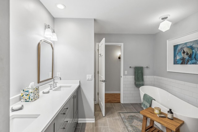 bathroom featuring vanity, a bathing tub, and hardwood / wood-style floors