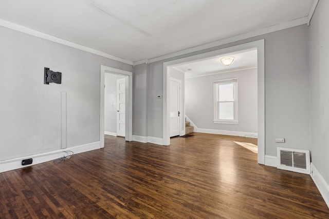 spare room featuring dark hardwood / wood-style flooring and ornamental molding