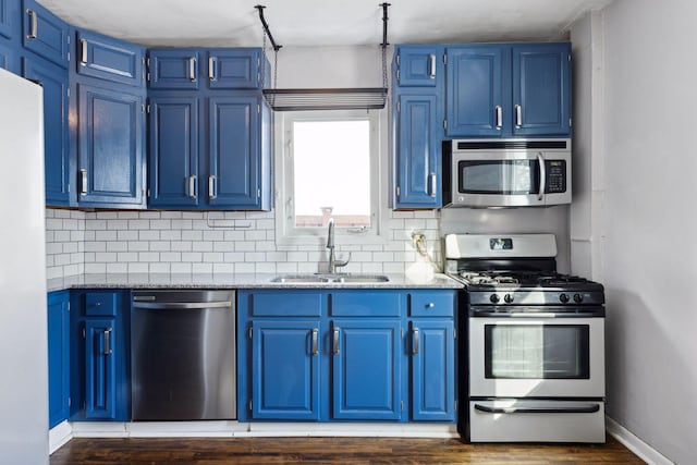 kitchen with blue cabinets, appliances with stainless steel finishes, and sink