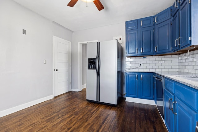 kitchen with blue cabinetry, tasteful backsplash, dark hardwood / wood-style flooring, stainless steel fridge, and dishwasher