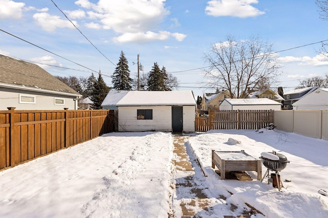 yard layered in snow with an outdoor structure