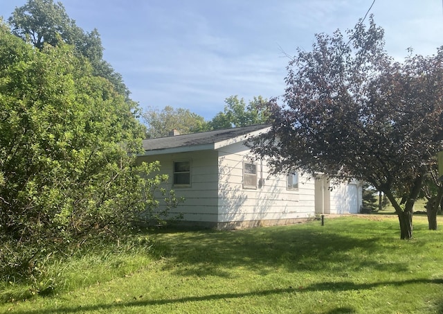 view of side of property with a yard