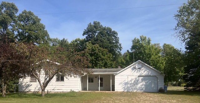 view of front of house with a garage and a front lawn