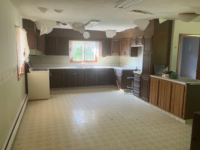 kitchen with dark brown cabinets, a textured ceiling, a baseboard heating unit, and white stove