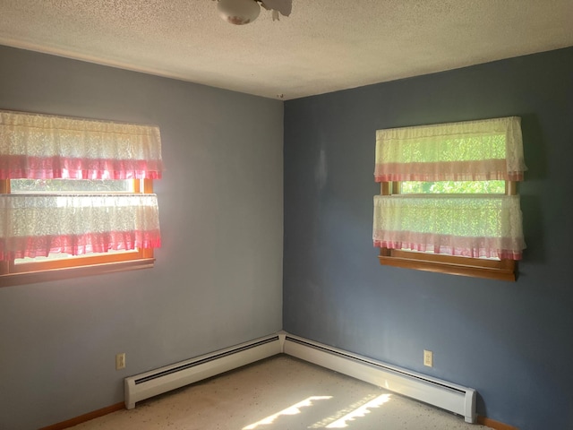 unfurnished room with a textured ceiling and baseboard heating