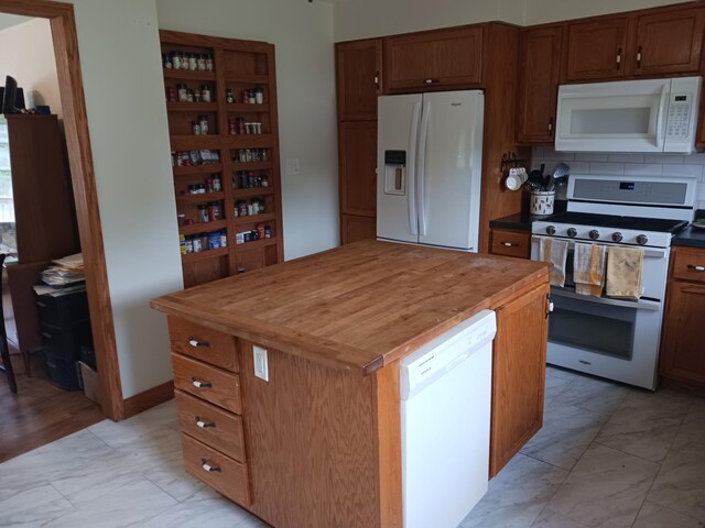 kitchen with white appliances, marble finish floor, wooden counters, and brown cabinets