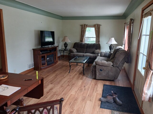 living area with visible vents, baseboards, and light wood-style floors